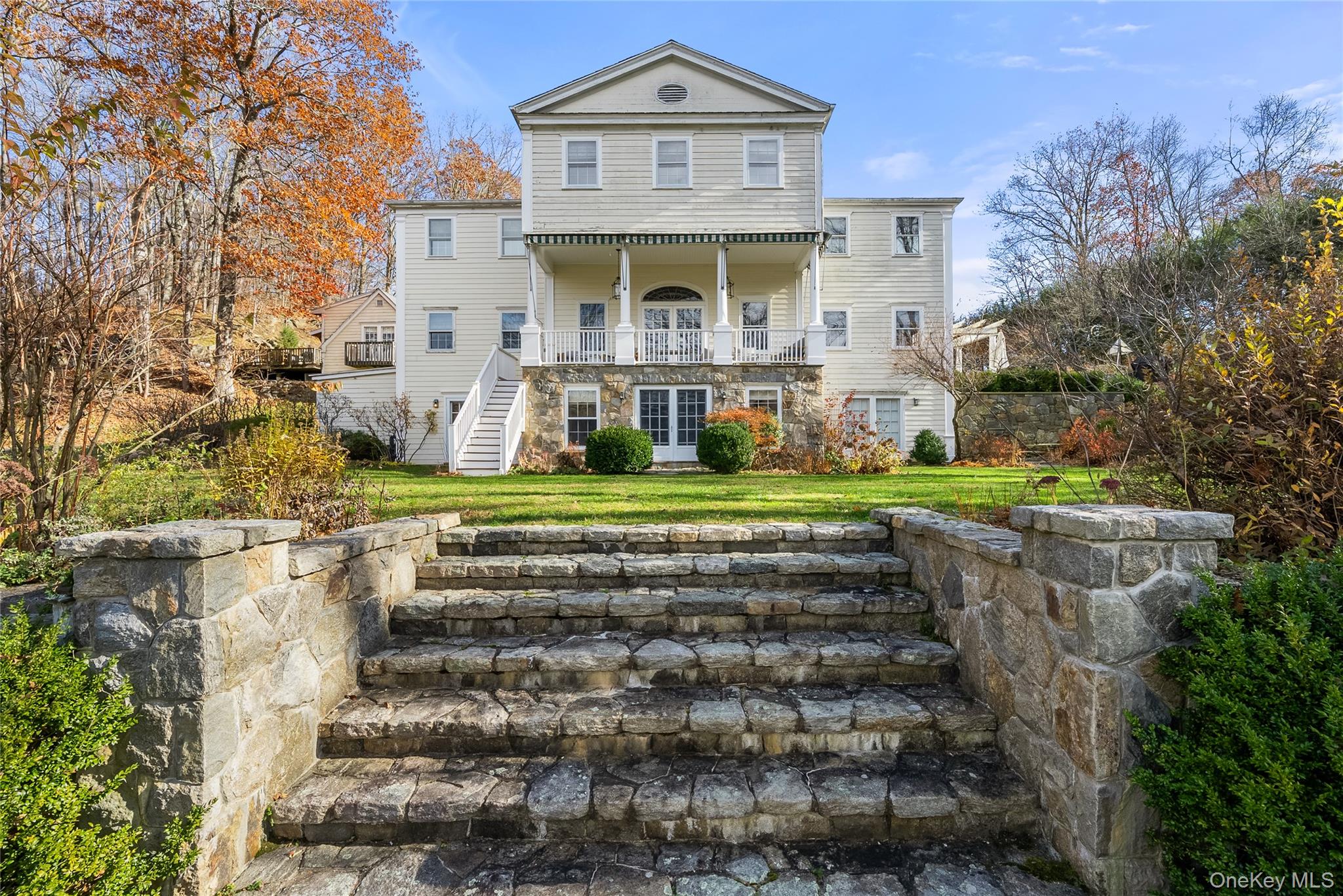 448 Long Ridge Road Pound Ridge, NY 10576 - Photo 49 of 49 Rear view of house with stairs, a lawn, and a balcony