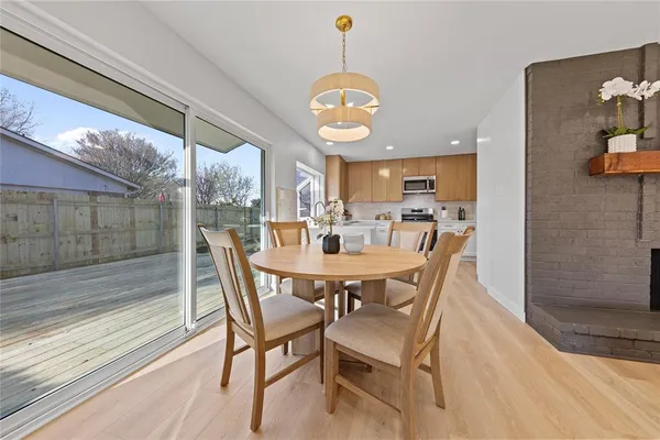 a view of a dining room with furniture wooden floor and chandelier