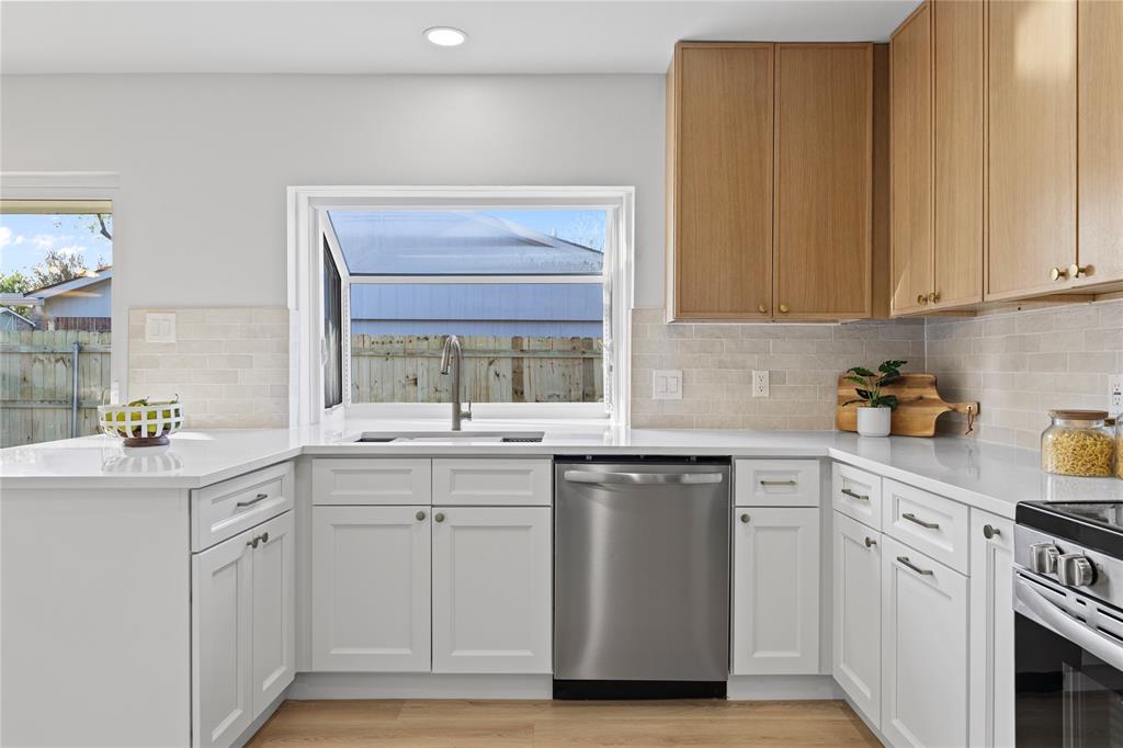 3121 Wayfarer Road Bedford, TX 76021 - Photo 14 of 32 Kitchen featuring dishwasher, light wood-style flooring, a peninsula, recessed lighting, and light stone countertops