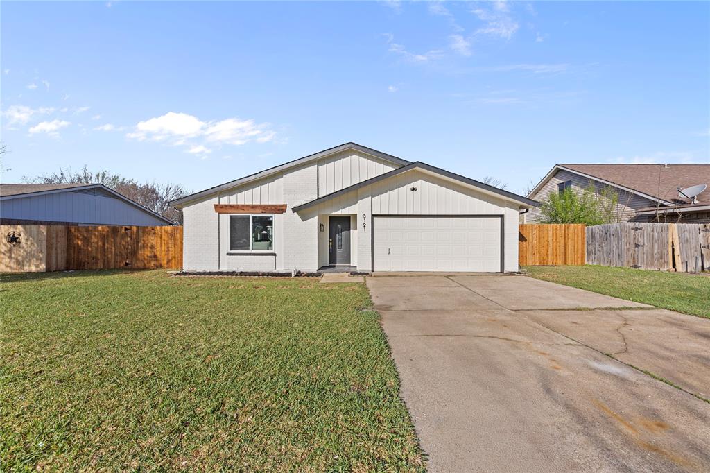 3121 Wayfarer Road Bedford, TX 76021 - Photo 2 of 32 View of front of property with concrete driveway, board and batten siding, and an attached garage