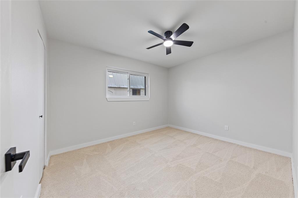 3121 Wayfarer Road Bedford, TX 76021 - Photo 26 of 32 Bedroom featuring light colored carpet and a ceiling fan