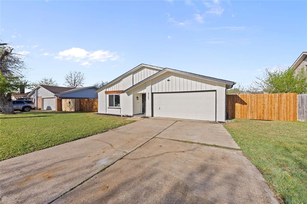 3121 Wayfarer Road Bedford, TX 76021 - Photo 4 of 32 View of front of house with driveway, board and batten siding, and a garage