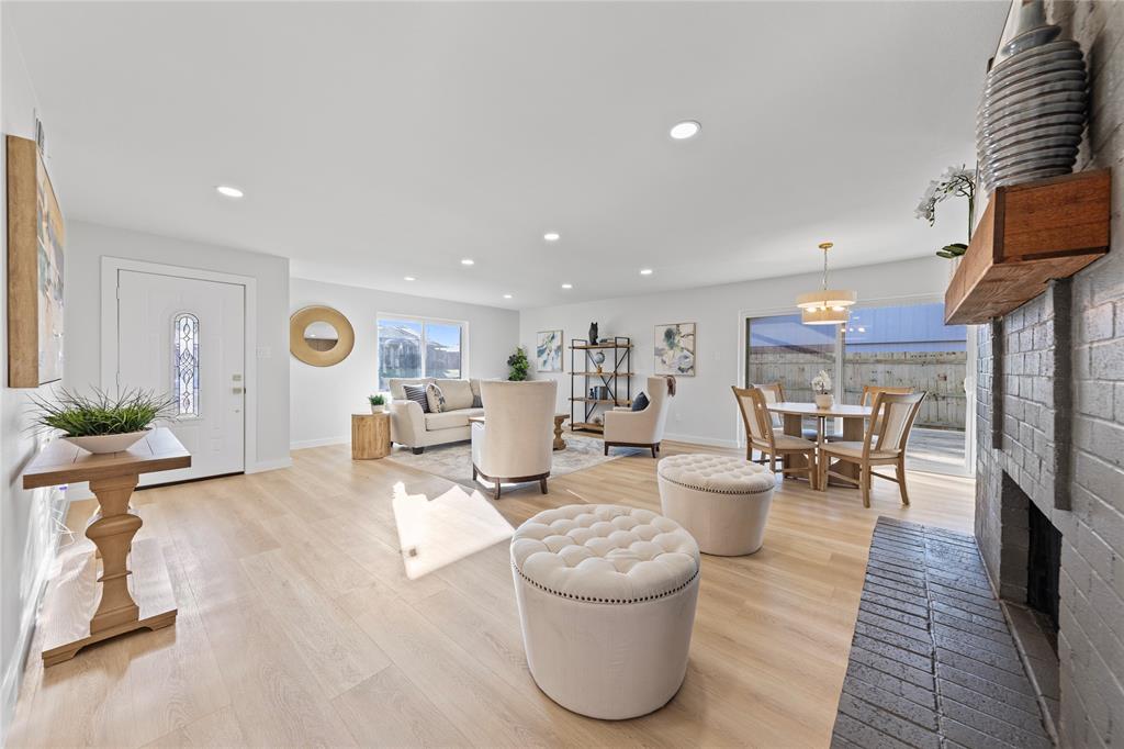 3121 Wayfarer Road Bedford, TX 76021 - Photo 6 of 32 Living area with light wood-style floors, a brick fireplace, and recessed lighting