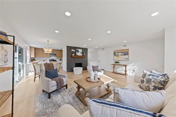 a living room with furniture kitchen view and a table