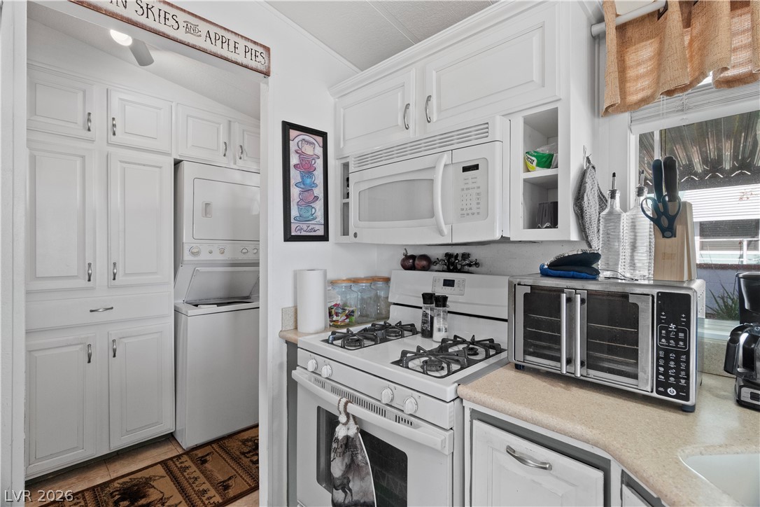 1655 Granada Street Laughlin, NV 89029 - Photo 15 of 76 Kitchen featuring white appliances, light countertops, and white cabinetry