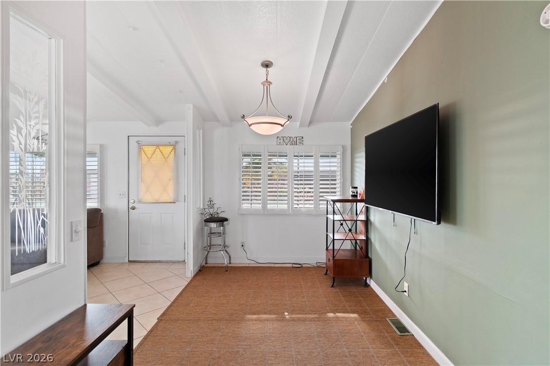 1655 Granada Street Laughlin, NV 89029 - Photo 18 of 76 Dining area featuring light tile patterned floors and vaulted ceiling with beams