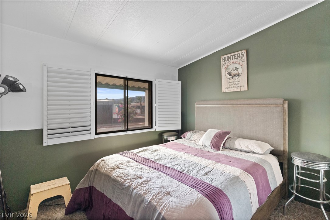 1655 Granada Street Laughlin, NV 89029 - Photo 21 of 76 Second Bedroom featuring vaulted ceiling and carpet floors