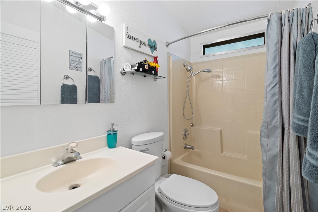 1655 Granada Street Laughlin, NV 89029 - Photo 23 of 76 Full Hall bathroom featuring vanity, shower / bathtub combination with curtain, and a textured wall