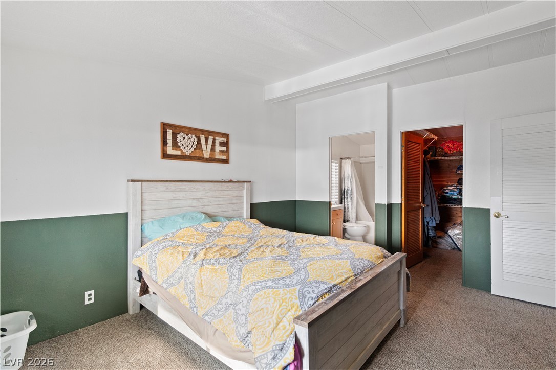 1655 Granada Street Laughlin, NV 89029 - Photo 25 of 76 Carpeted Primary bedroom featuring a walk in closet and ensuite bath