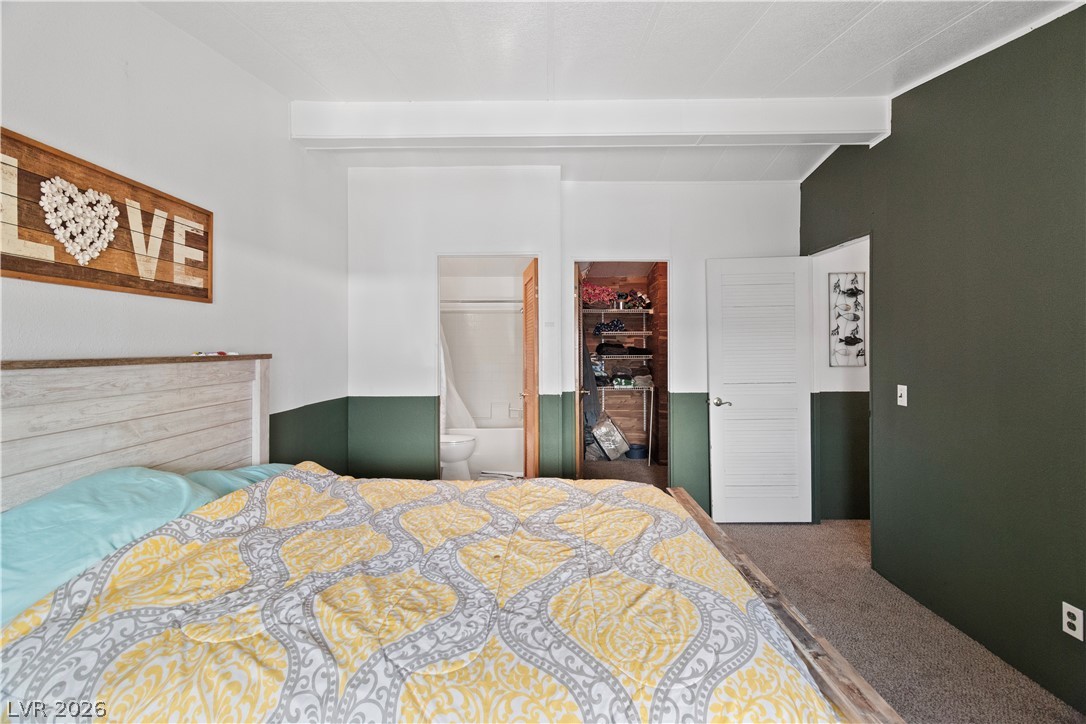 1655 Granada Street Laughlin, NV 89029 - Photo 26 of 76 Primary Bedroom featuring carpet flooring, connected bathroom, and beam ceiling