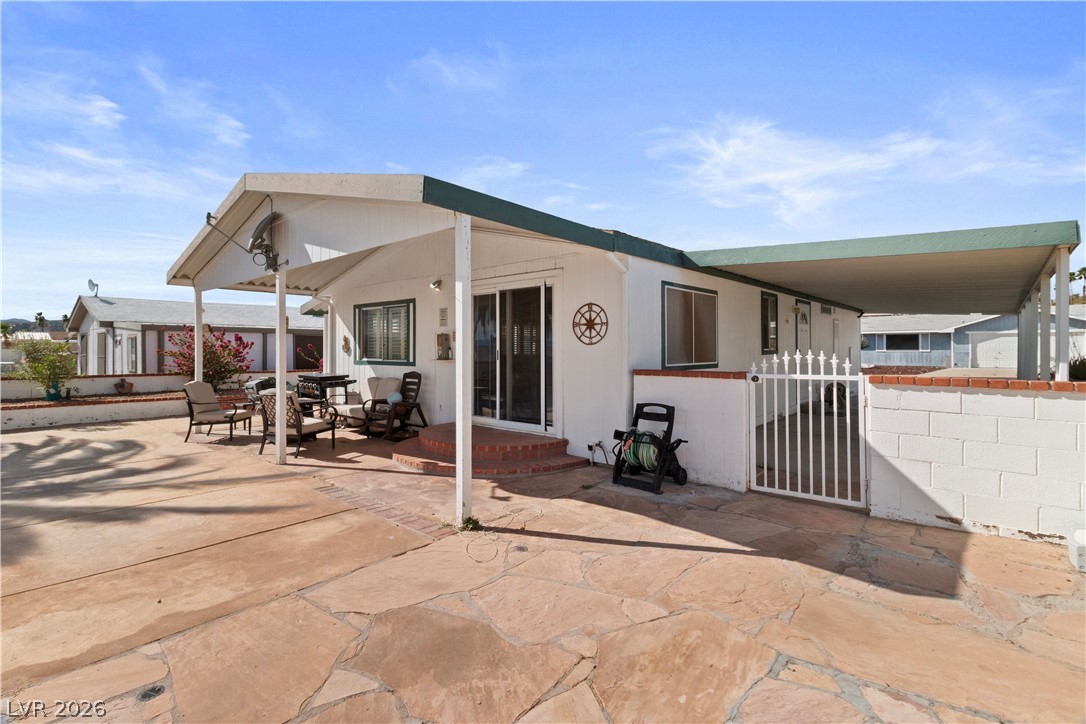1655 Granada Street Laughlin, NV 89029 - Photo 32 of 76 Rear view of house featuring a gate and a patio