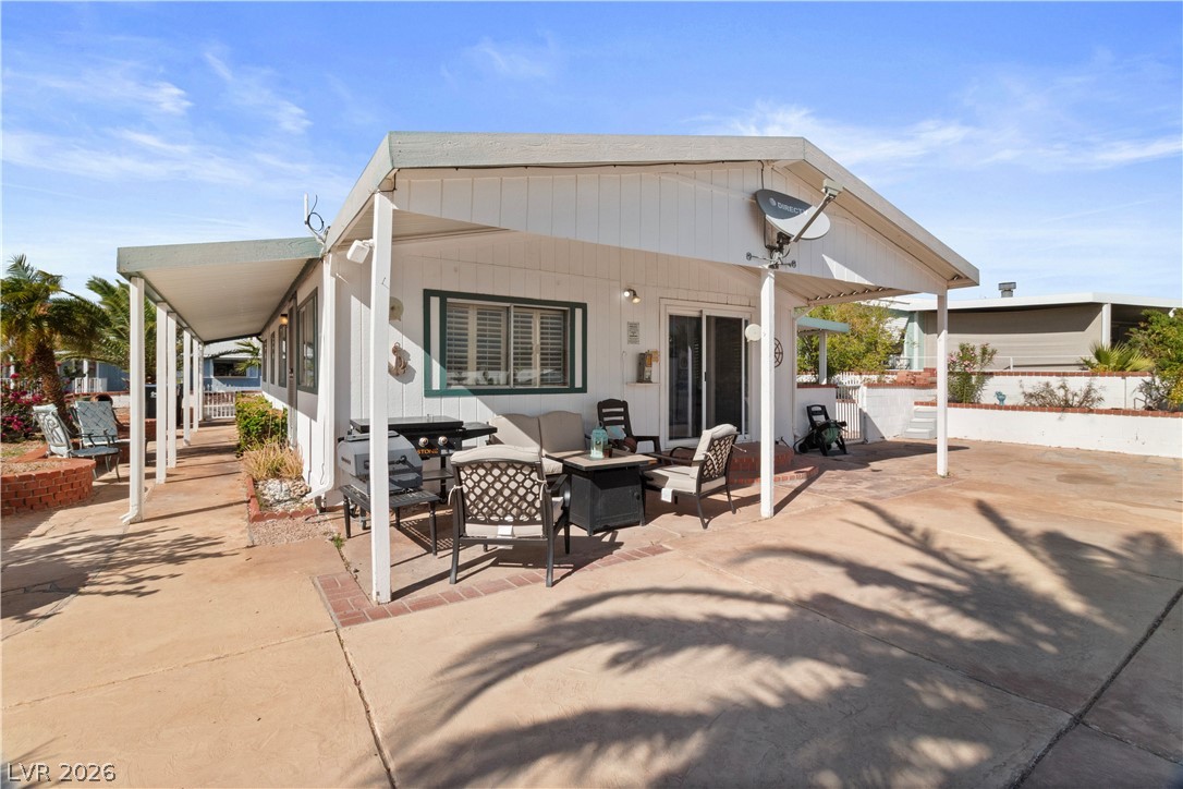 1655 Granada Street Laughlin, NV 89029 - Photo 34 of 76 Rear view of property with an outdoor hangout area and a patio
