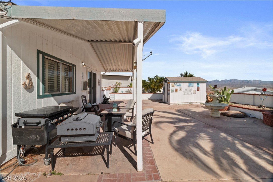 1655 Granada Street Laughlin, NV 89029 - Photo 36 of 76 View of patio / terrace featuring an outdoor structure, area for grilling, and a mountain view