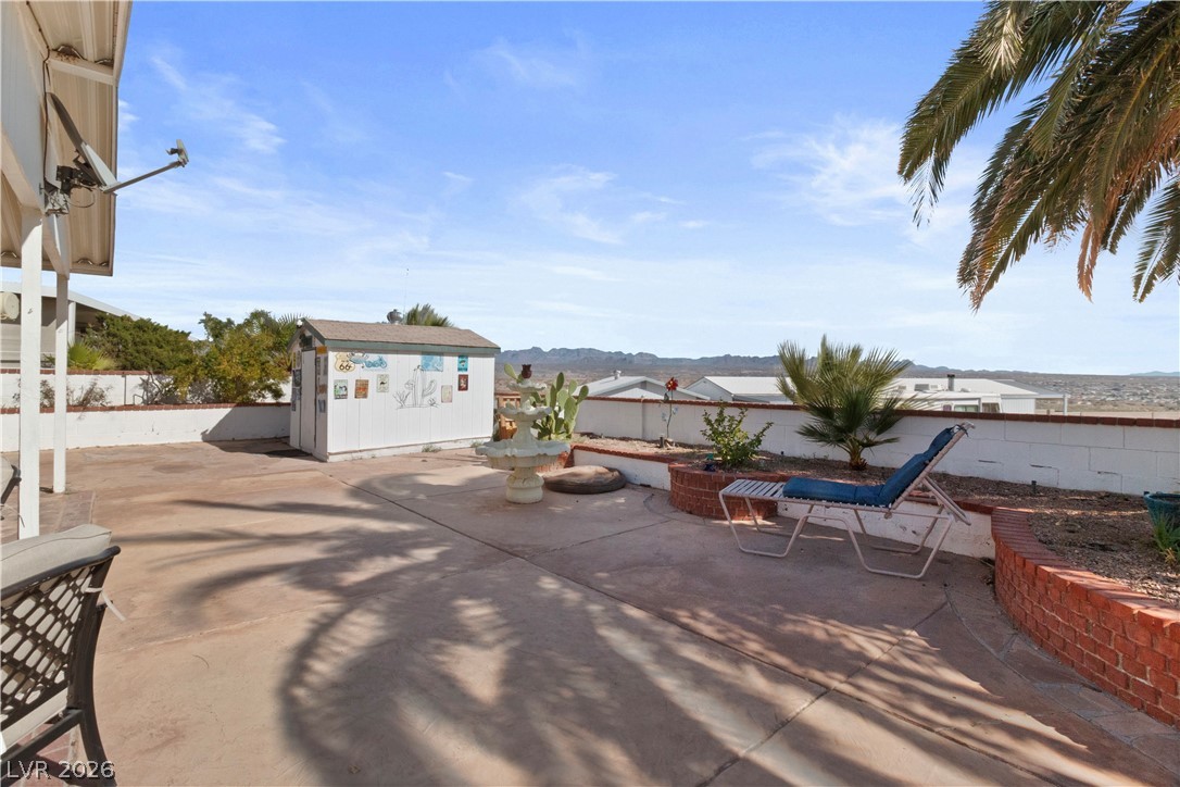 1655 Granada Street Laughlin, NV 89029 - Photo 38 of 76 Fenced backyard with a patio area and a shed