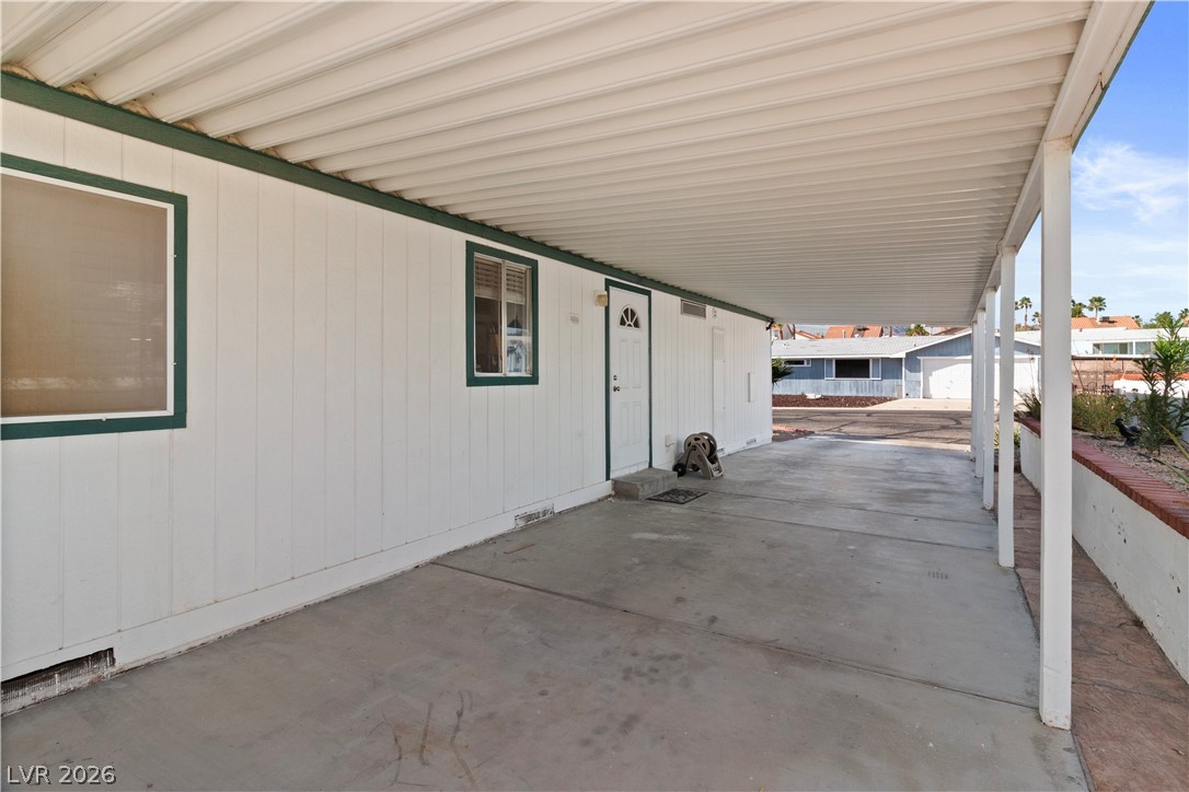 1655 Granada Street Laughlin, NV 89029 - Photo 49 of 76 View of patio / terrace featuring an attached carport and an outdoor structure