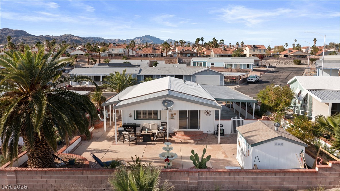 1655 Granada Street Laughlin, NV 89029 - Photo 55 of 76 Rear view of house with a patio, an outbuilding, outdoor lounge area, and a mountain view