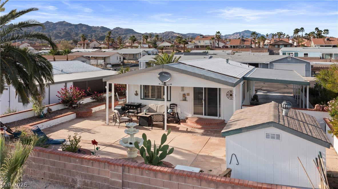 1655 Granada Street Laughlin, NV 89029 - Photo 57 of 76 Rear view of property with outdoor lounge area, a residential view, a mountain view, and a patio area