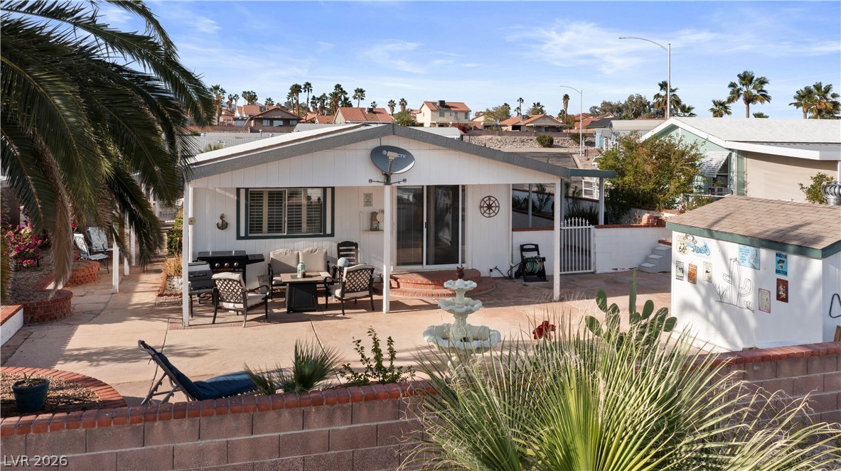 1655 Granada Street Laughlin, NV 89029 - Photo 58 of 76 Rear view of house featuring a patio and an outdoor living space