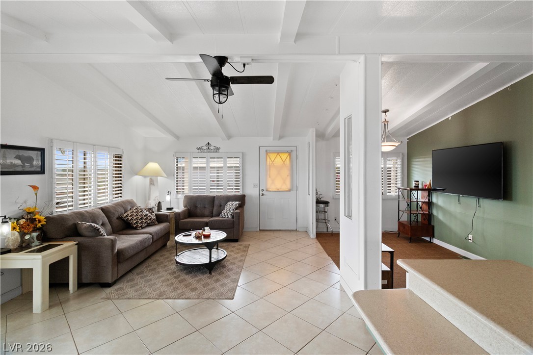 1655 Granada Street Laughlin, NV 89029 - Photo 7 of 76 Living room featuring lofted ceiling with beams, ceiling fan, and light tile patterned floors