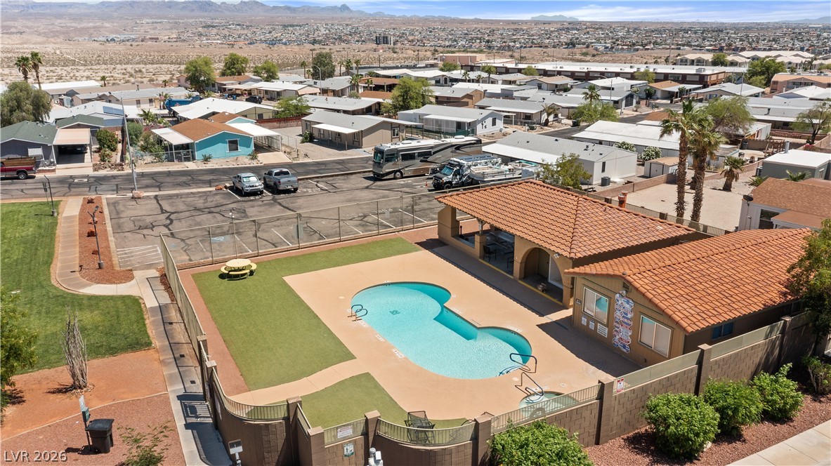 1655 Granada Street Laughlin, NV 89029 - Photo 74 of 76 Aerial View of community park area, community pool, and available RV / Boat parking with a mountain view