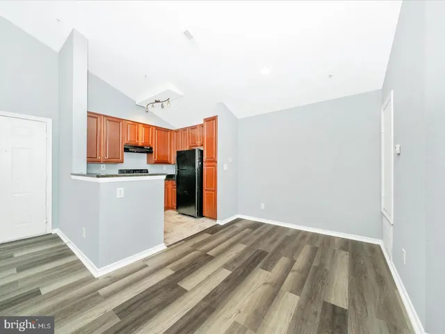 a view of a kitchen with wooden floor