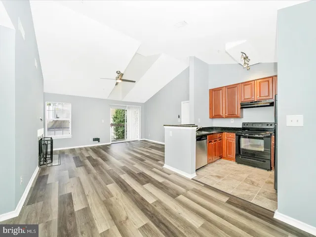 a open kitchen with sink and refrigerator