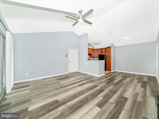 a view of a livingroom with a hardwood floor and a ceiling fan