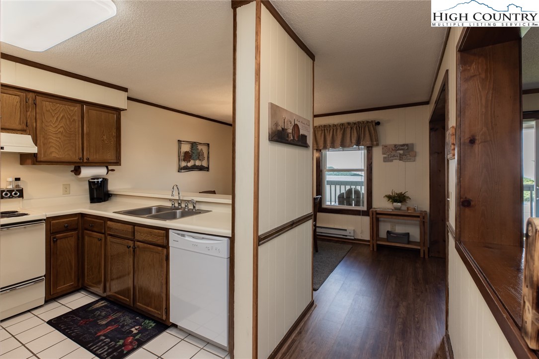 301 Pinnacle Inn Road, Unit 2110 Beech Mountain, NC 28604 - Photo 15 of 48 a kitchen with a refrigerator a sink and wooden floor