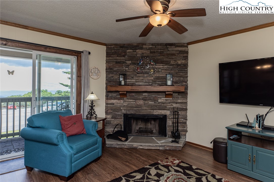 301 Pinnacle Inn Road, Unit 2110 Beech Mountain, NC 28604 - Photo 4 of 48 a living room with furniture a flat screen tv and a fireplace