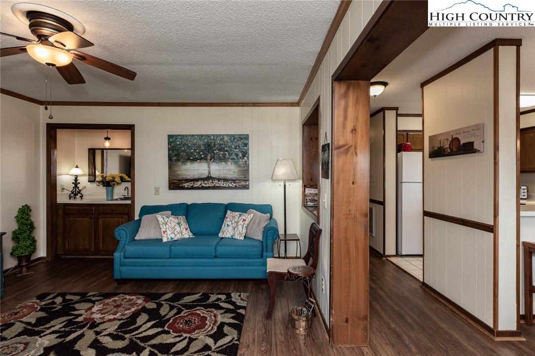 301 Pinnacle Inn Road, Unit 2110 Beech Mountain, NC 28604 - Photo 8 of 48 a living room with stainless steel appliances furniture a rug and a chandelier