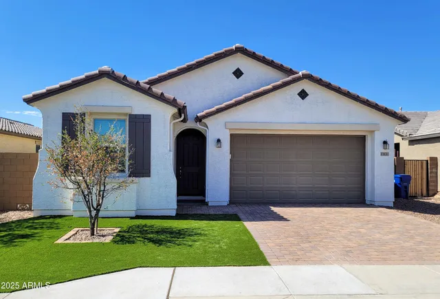 a front view of a house with a yard and garage