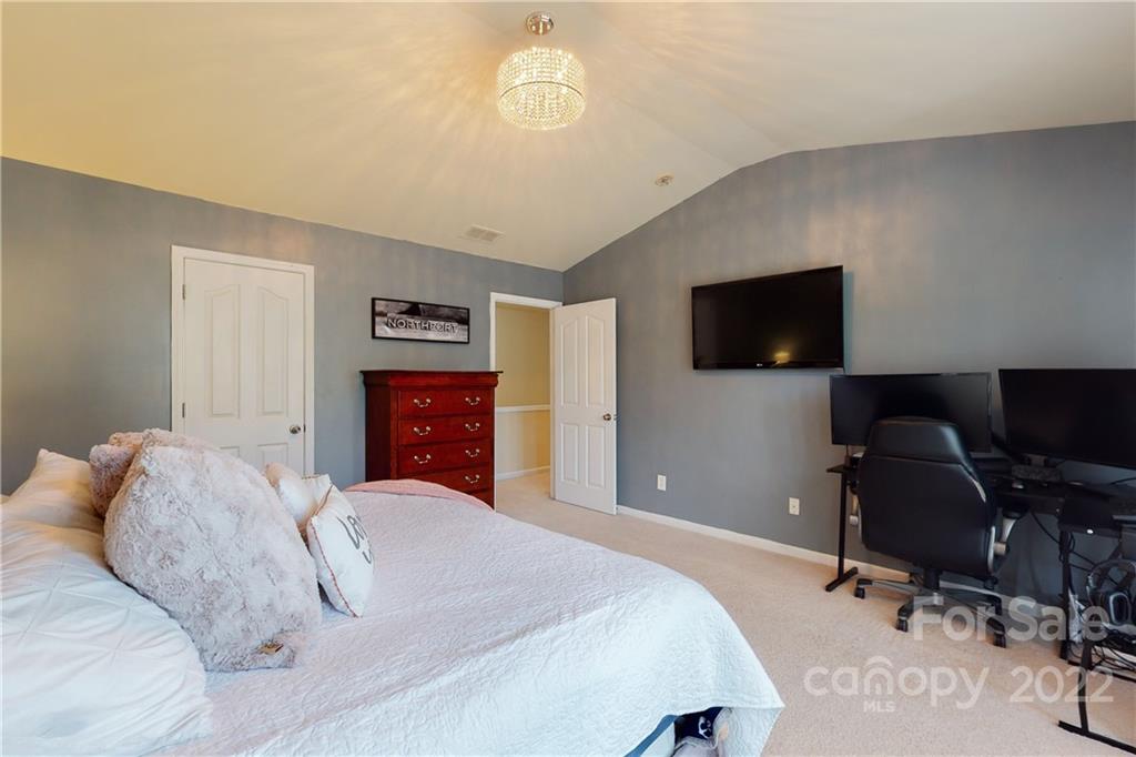 9136 Redmond Trace Road Charlotte, NC 28277 - Photo 20 of 37 a bedroom with a large bed and a flat tv screen on dresser