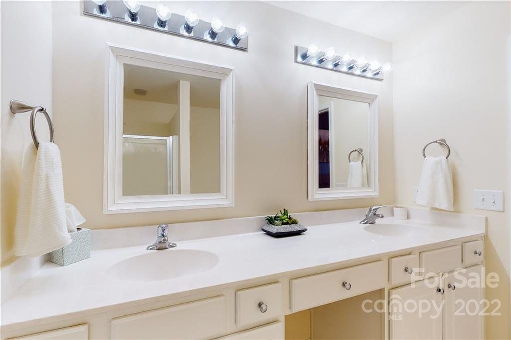 9136 Redmond Trace Road Charlotte, NC 28277 - Photo 23 of 37 a bathroom with a sink vanity and mirror