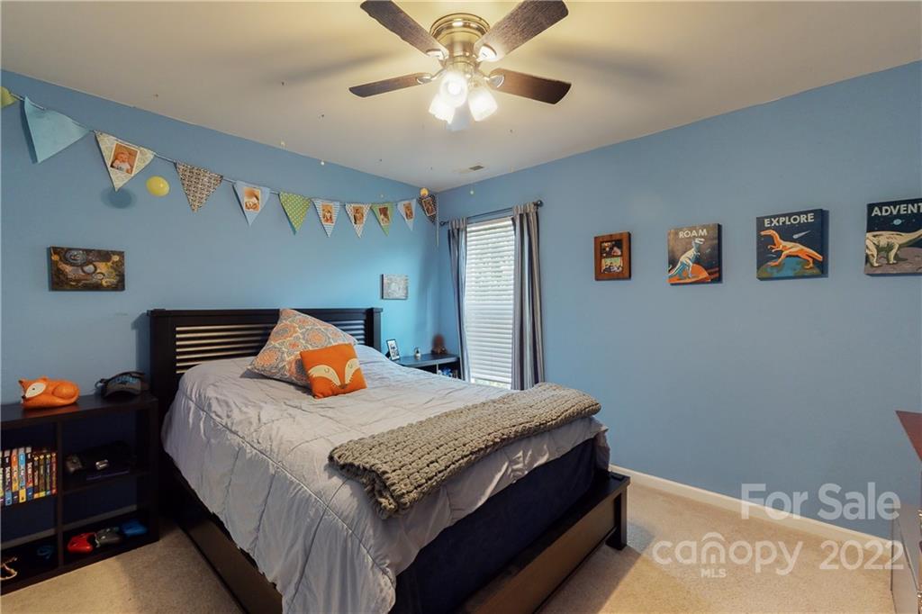 9136 Redmond Trace Road Charlotte, NC 28277 - Photo 29 of 37 a bedroom with a bed and a chandelier