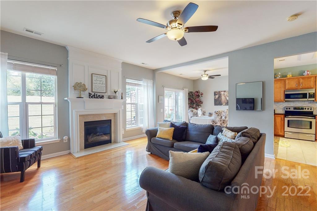 9136 Redmond Trace Road Charlotte, NC 28277 - Photo 6 of 37 a living room with furniture a fireplace and a flat screen tv