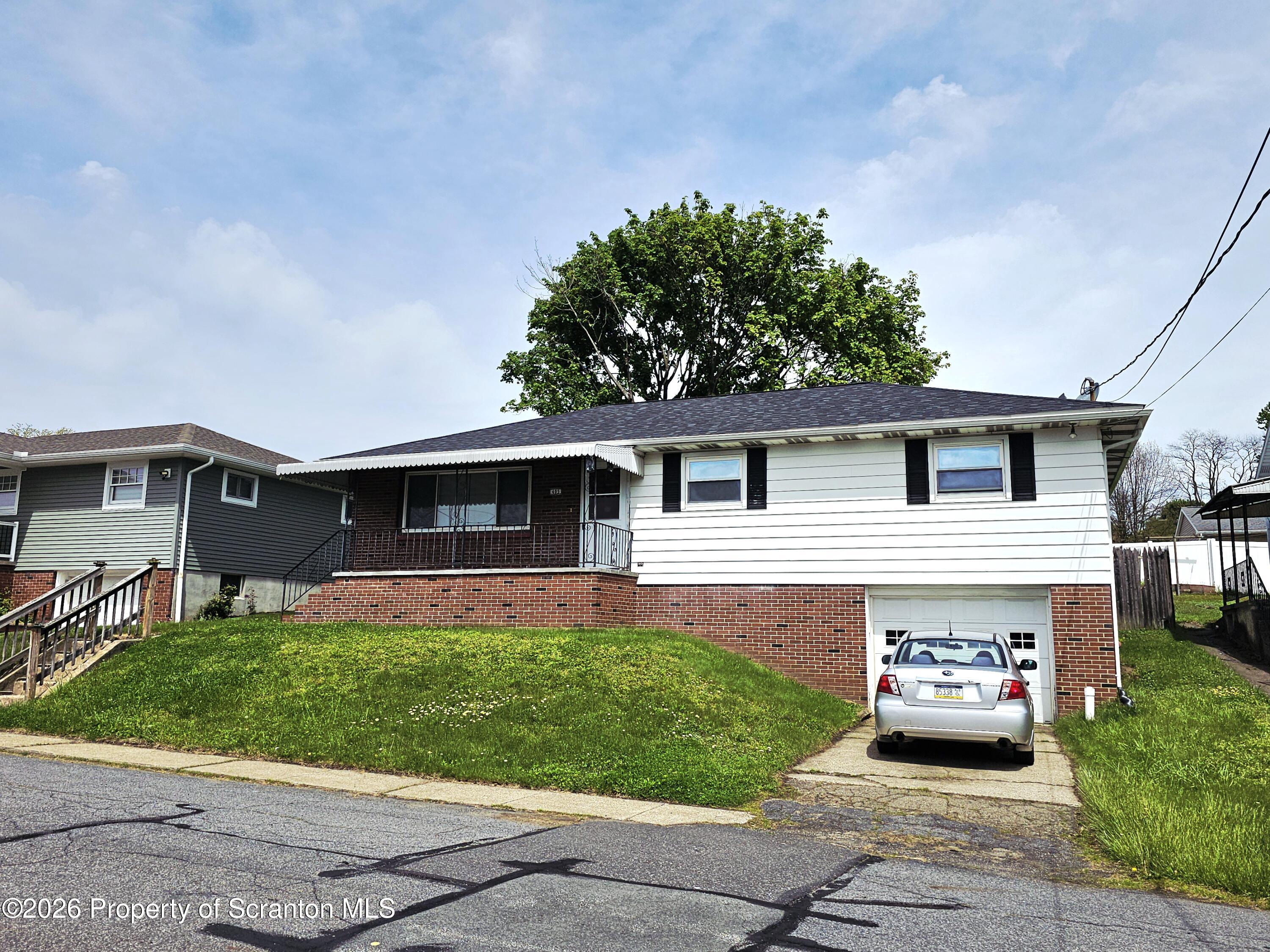 405 Baker Street Taylor, PA 18517 - Photo 2 of 36 a front view of house with yard and green space