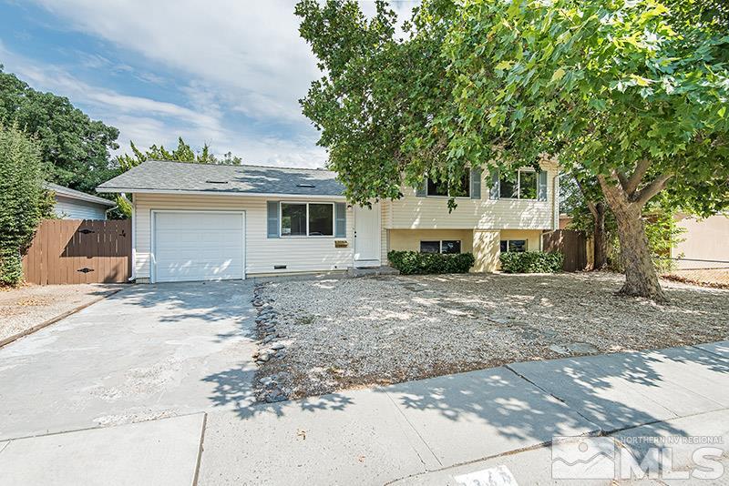 1360 Ebbetts Drive Reno, NV 89503 - Photo 1 of 1 a front view of a house with a yard and garage
