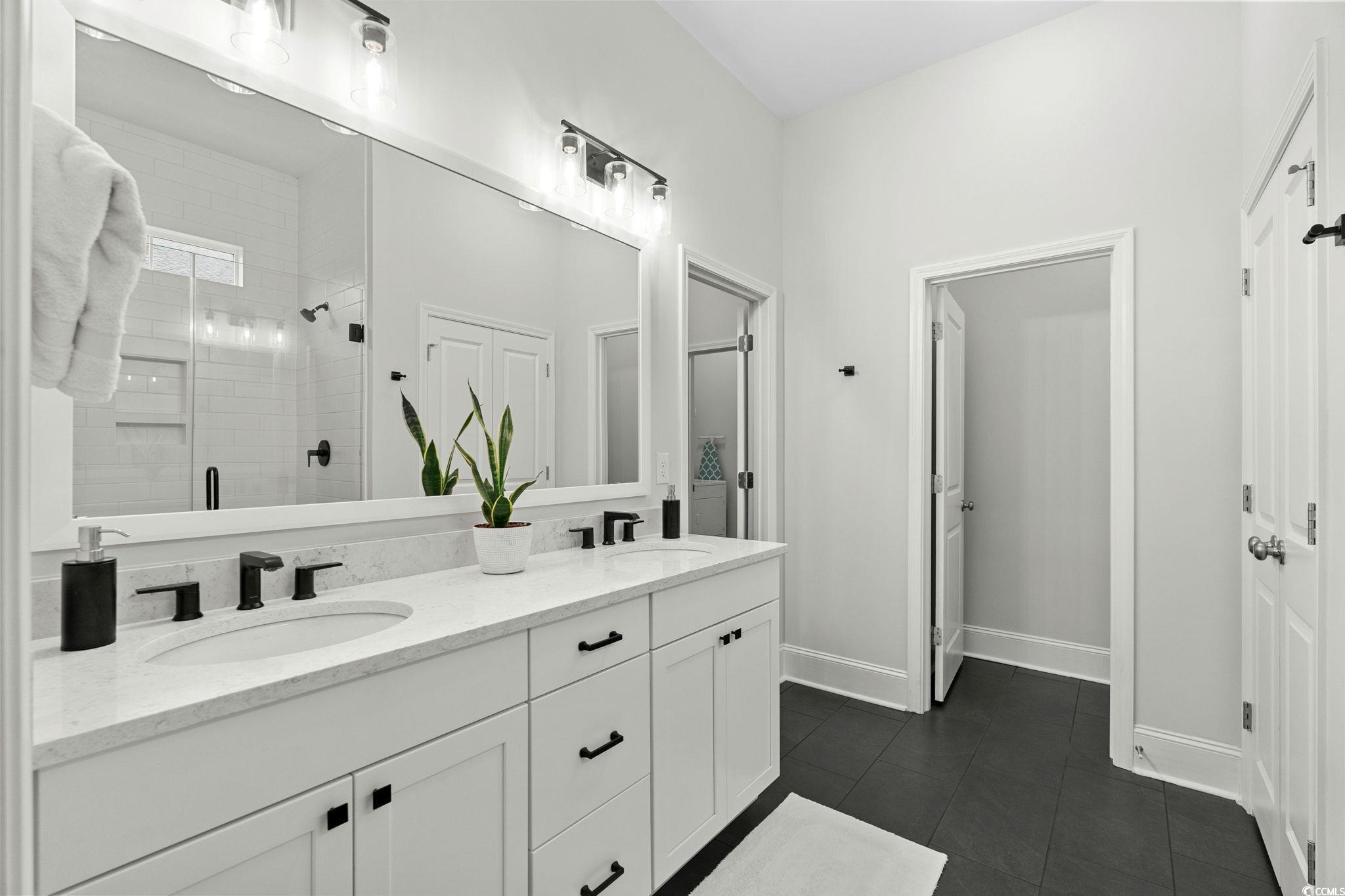 191 Blackwater Drive Murrells Inlet, SC 29576 - Photo 17 of 40 Full bathroom with a shower stall, double vanity, and dark tile patterned floors