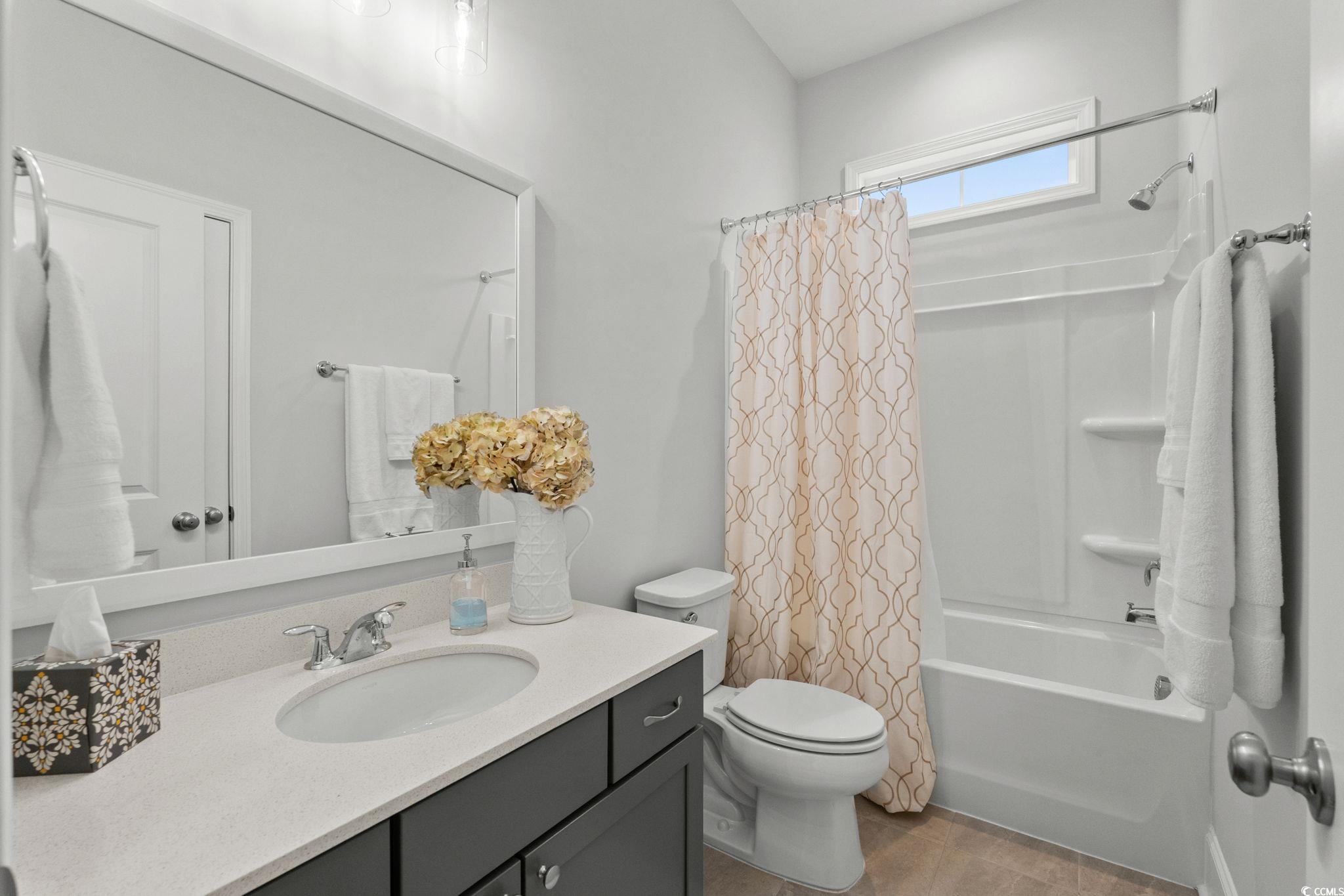191 Blackwater Drive Murrells Inlet, SC 29576 - Photo 25 of 40 Bathroom with shower / bathtub combination with curtain, vanity, and light tile patterned flooring