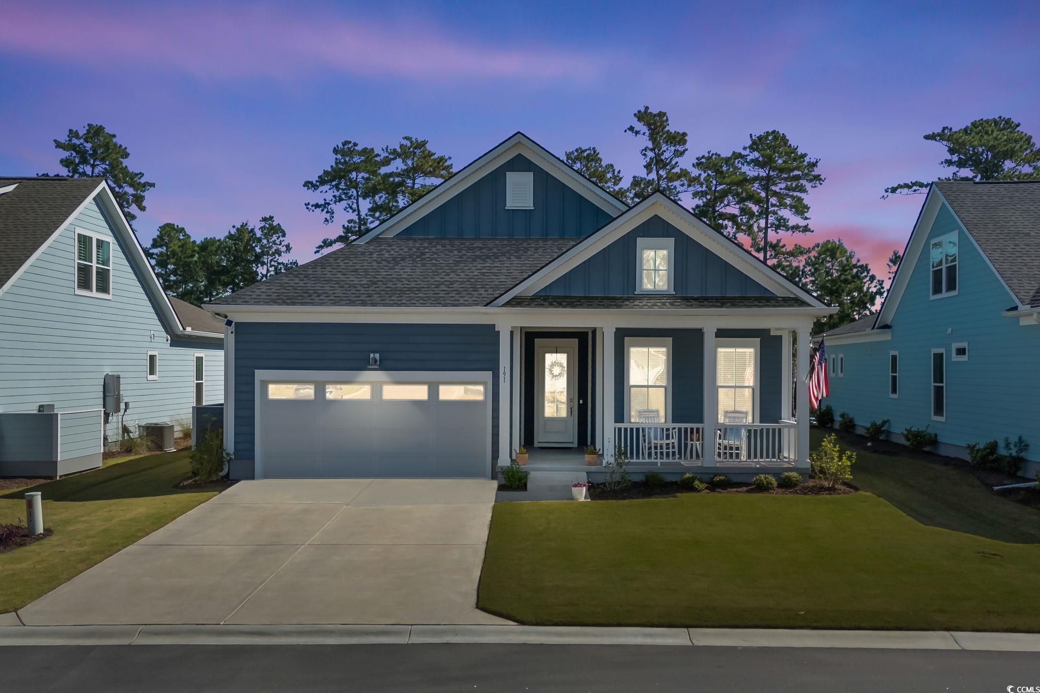 191 Blackwater Drive Murrells Inlet, SC 29576 - Photo 34 of 40 View of front facade with board and batten siding, a porch, a front yard, driveway, and a garage