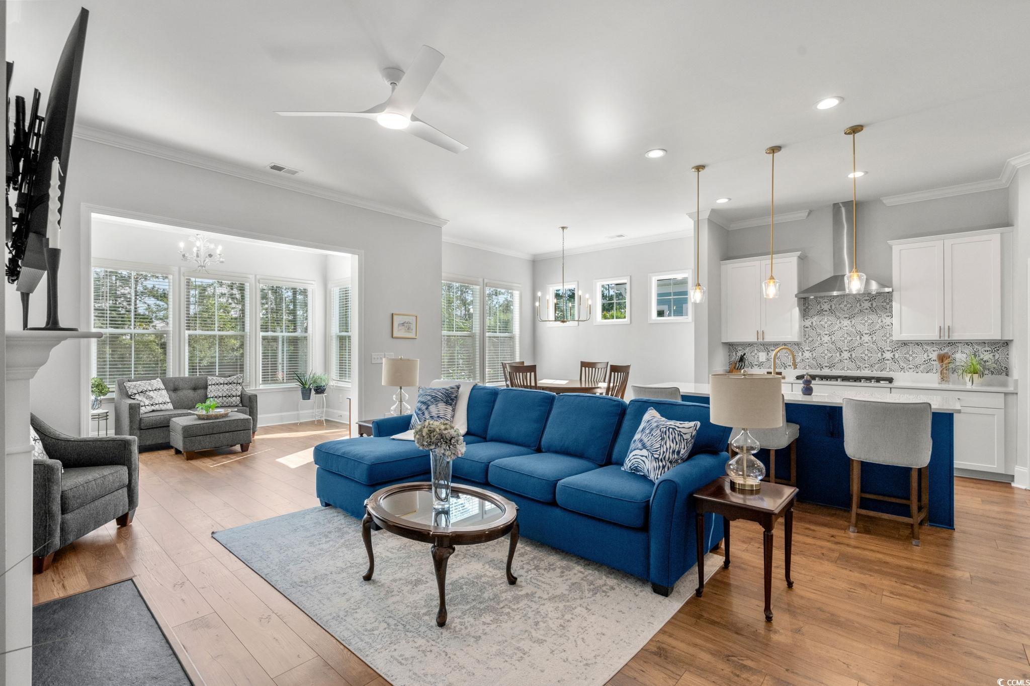 191 Blackwater Drive Murrells Inlet, SC 29576 - Photo 8 of 40 Living room with crown molding, light wood-style flooring, a ceiling fan, a chandelier, and recessed lighting