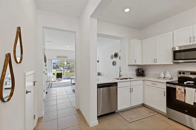 a kitchen with a sink dishwasher a refrigerator and a stove top oven