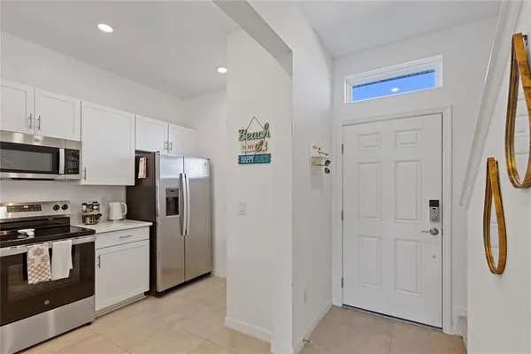 a kitchen with stainless steel appliances a refrigerator a stove a microwave and cabinets