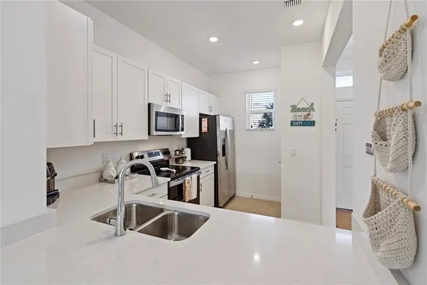 a kitchen with stainless steel appliances a microwave a stove and a refrigerator