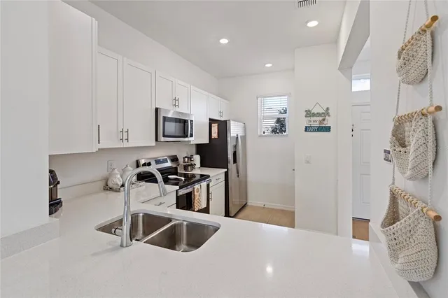a kitchen with stainless steel appliances a microwave a stove and a refrigerator
