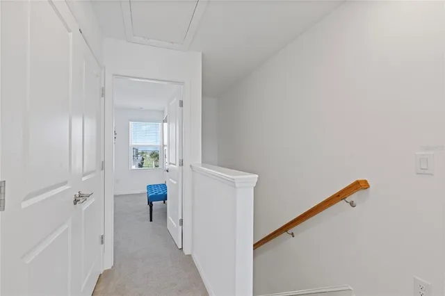 a view of a hallway with bathroom and front door