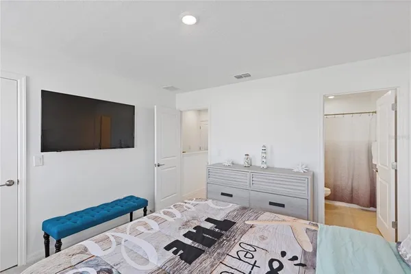 a bedroom with a bed and a television