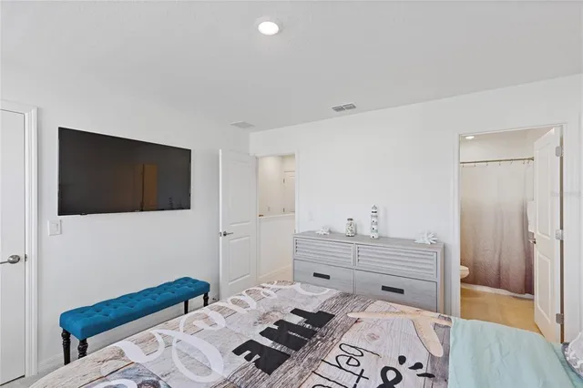 a bedroom with a bed and a television