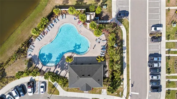 an aerial view of a swimming pool patio and outdoor seating