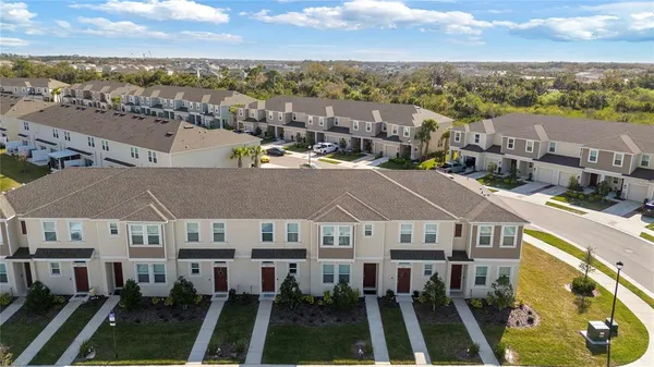 an aerial view of a house with a yard